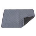 Grey rectangular pet floor pad with a honeycomb pattern and one corner lifted to show the dark backing.