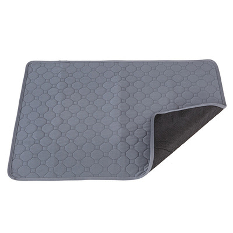Grey rectangular pet floor pad with a honeycomb pattern and one corner lifted to show the dark backing.